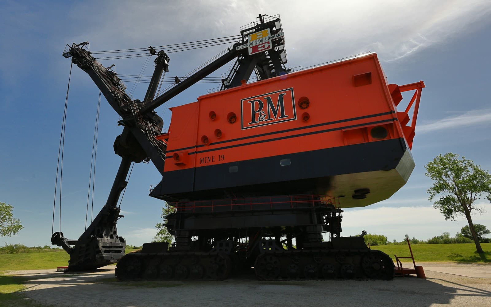 Large tracked industrial excavator displayed outdoors